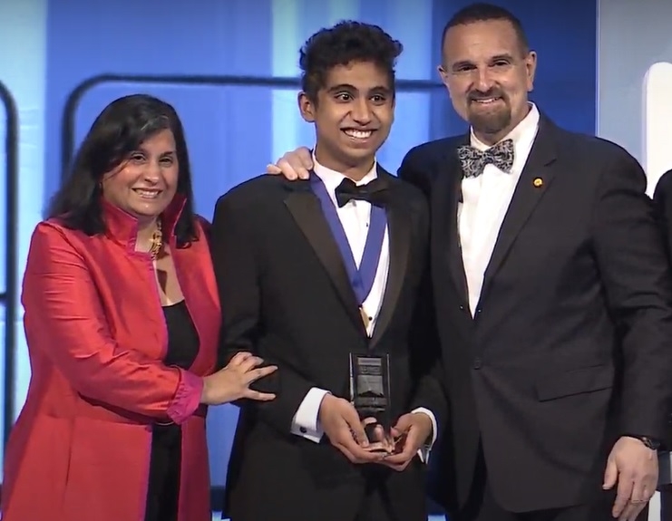 Neel Moudgal, the winner of the Regeneron Science Talent competition prize of $250,000, is flanked by Maya Ajmera, of the Society for Science and George Yancopoulos, president of Regeneron Pharmaceuticals, at the awards ceremony on Tuesday, March 14, 2023. (Photo Source: Society for Science)