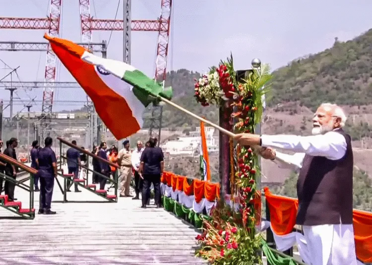 PM Narendra Modi waves the Tiranga as he inaugurates Chenab bridge Anji Bridge in Jammu and Kashmir
