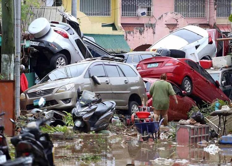 Vehicles lie piled on after flooding caused by Typhoon Kalmaegi in Cebu city, central Philippines, Tuesday, Nov. 4, 2025. (AP Photo/Jacqueline Hernandez)